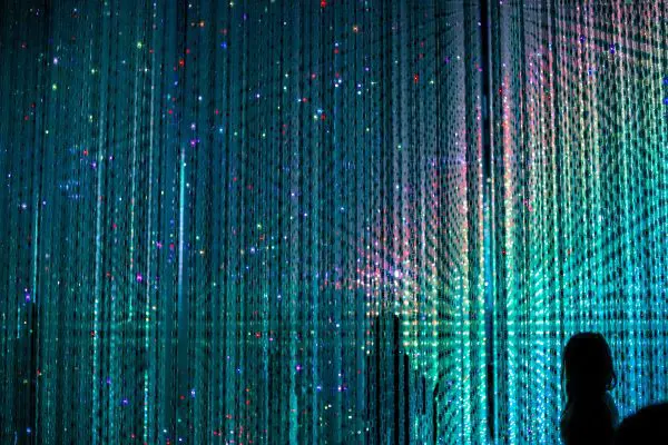 An immersive digital art installation at TeamLab Planets Tokyo, showing a wall of soft glowing lights. 