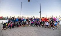 Group of runners posing for a photo in New York City, after taking part in a 5km shake out run with Sports Tours International.