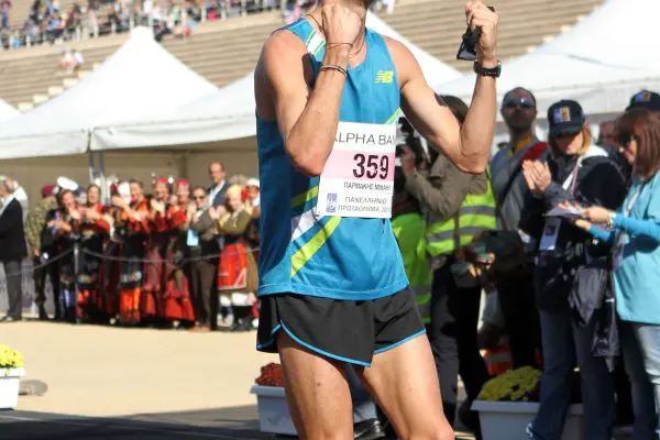 A runner smiling after finishing the Athens marathon
