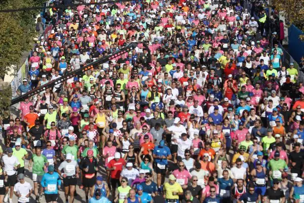 Athens Marathon runners crossing the start line of the race course