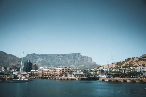 A panoramic view of Table Mountain towering above the V&A Waterfront in Cape Town, South Africa.