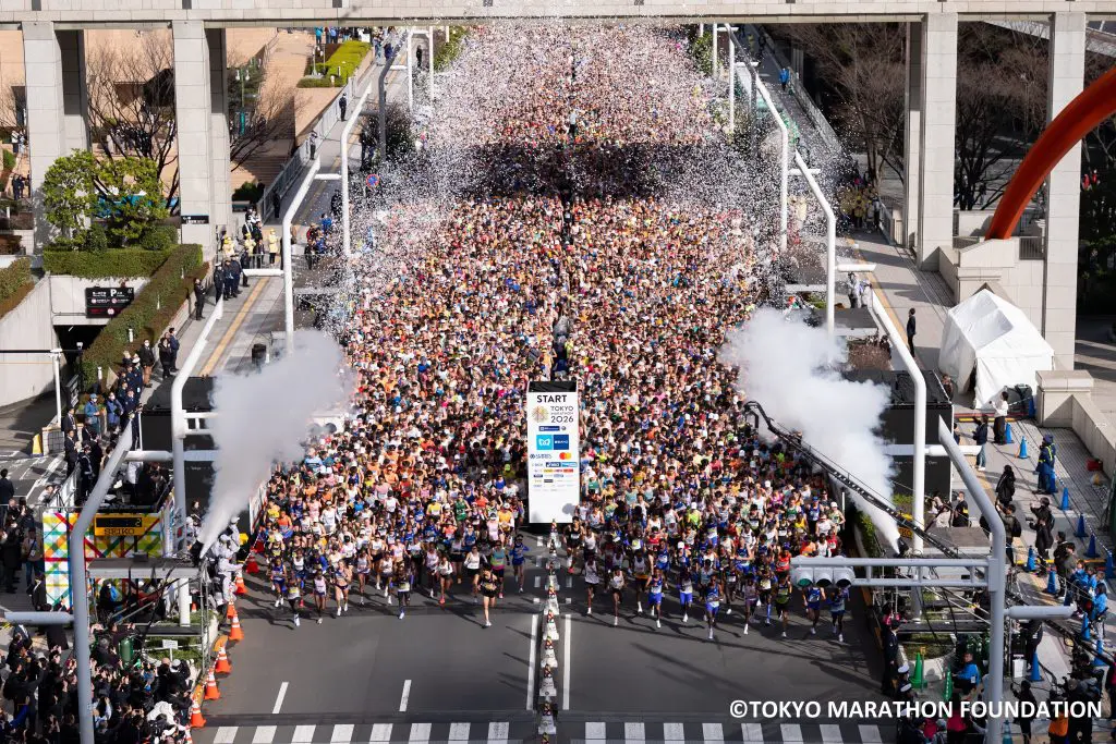 Birds eye view of runners at the start line of the Tokyo Marathon, in Japan. With white confetti in the air as a signal for the runners to go.