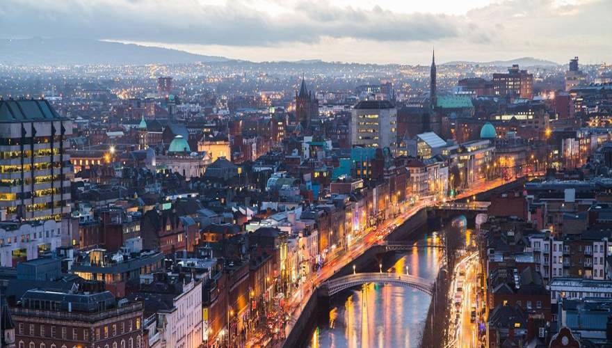 Dublin at night, city lights shining along the river bank