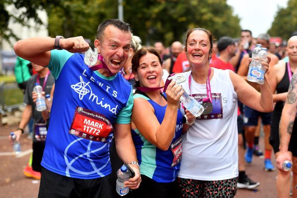 Half Marathon finishers at the Cardiff half holding their medal proudly
